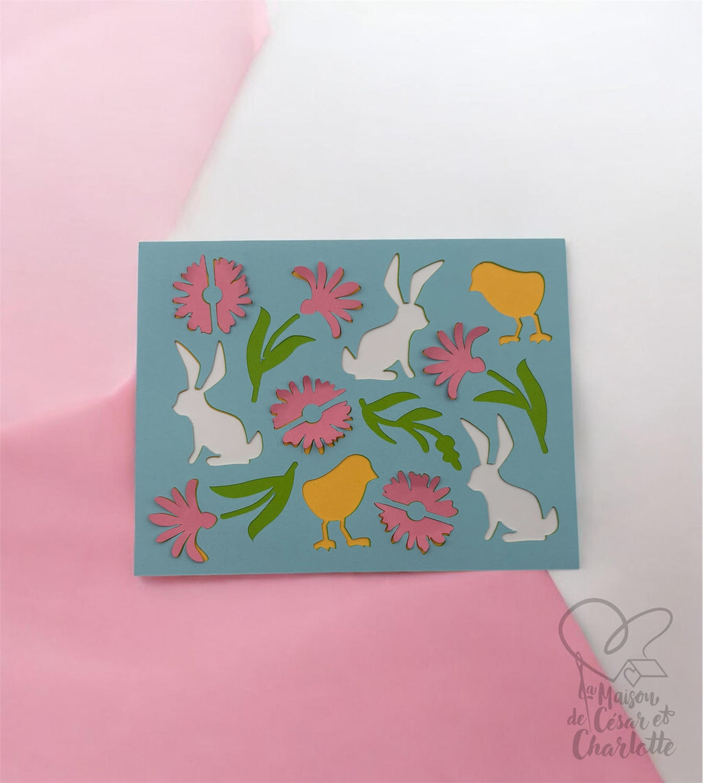 Carte de Pâques artisanale aux couleurs douces et printanières, décorée de petits lapins, poussins et fleurs