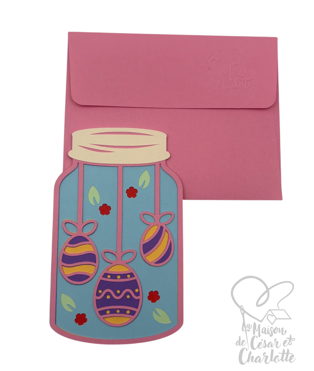 Carte de Pâques en bocal,artisanale originale en forme de bocal, décorée de jolis œufs suspendus aux motifs colorés.